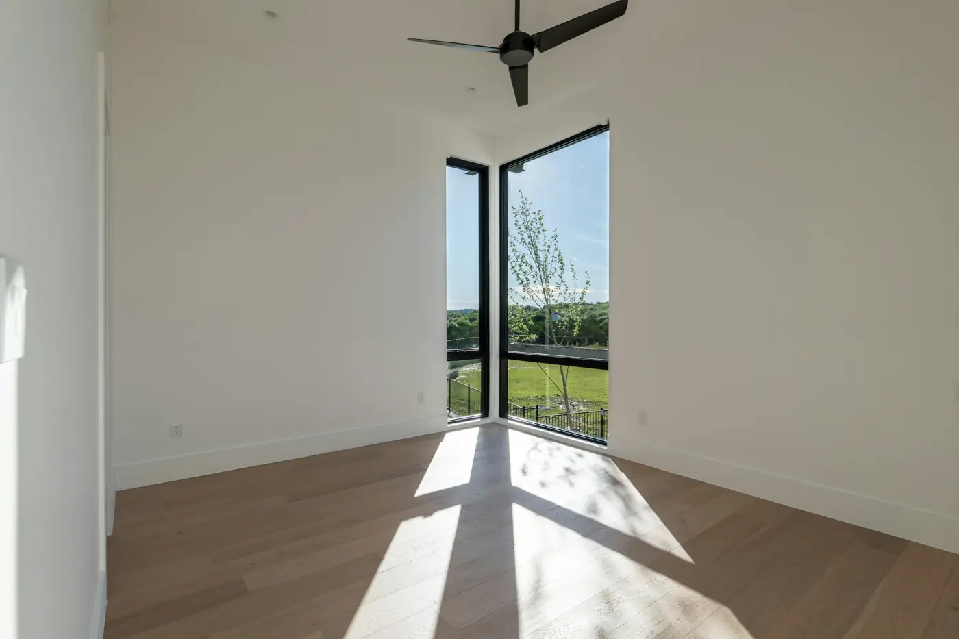 Empty, finished new room with sunlight on the floor